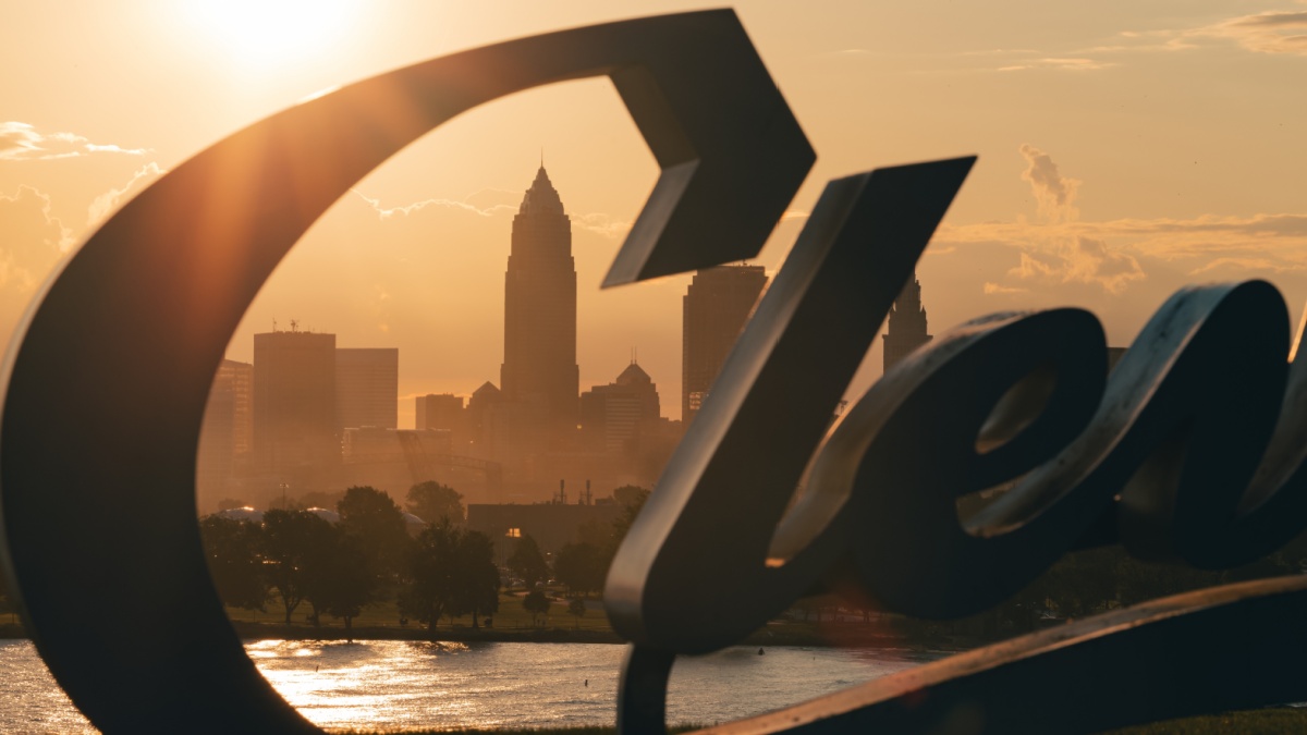 Cleveland skyline behind the Cleveland script sign at Sunrise, moody morning sunrise, midwest city, Browns, Guardians (MLB), City