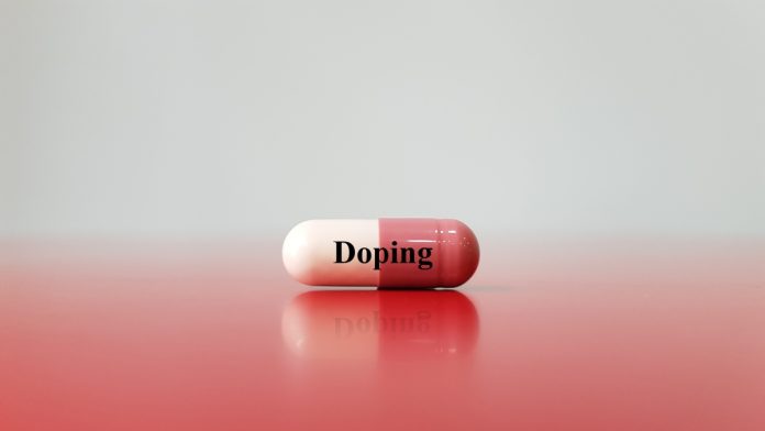 Doping- Doping drug (anabolic capsule) is the used of banned athletic performance enhancing drug by athlete in competitive sport. It is unethical and prohibited. Medical drug abuse in sport medicine concept.