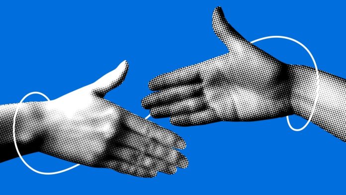 Goldman-X-Excel Hands reach out to each other, representing Goldman Sachs and Excel deal