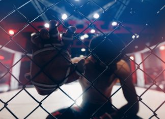 OKTAGON says fighters won’t risk match-fixing Portrait man MMA fighter on octagon ring. Fighting Championship, dark background.