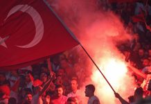 Beşiktaş speaks out as Turkish football scandal spreads Berlin, Germany - July 6, 2024: Turkish supporters burn flares during the UEFA EURO 2024 quarter-final game Netherlands v Turkey at Olympiastadion in Berlin, Germany.