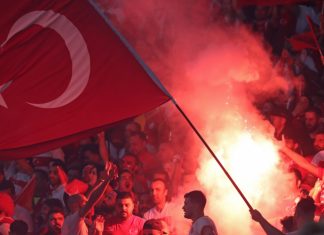 Beşiktaş speaks out as Turkish football scandal spreads Berlin, Germany - July 6, 2024: Turkish supporters burn flares during the UEFA EURO 2024 quarter-final game Netherlands v Turkey at Olympiastadion in Berlin, Germany.