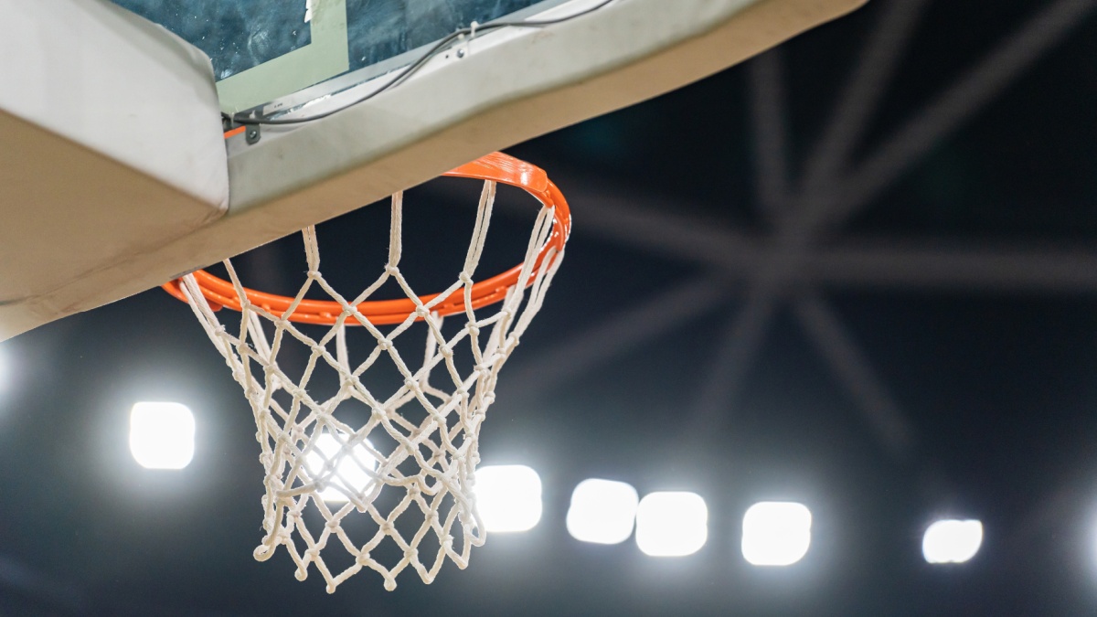 Basketball hoop hanging in a sports stadium waiting for the ball.