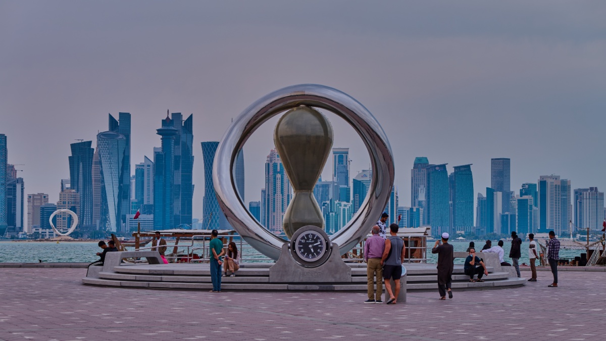 Doha, Qatar-April 20 2025:The FIFA World Cup Qatar 2022 Official Countdown Clock with people walking and Doha skyline in background.