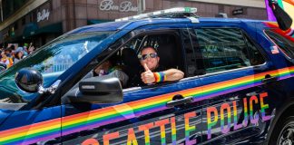 World Cup ‘Pride Match’ in Seattle to feature anti-LGBT nations Seattle, WA / USA - 30 June 2019: A Seattle police officer passes by in a cruiser during the Seattle Pride Parade showing support for LGBTQ rights.