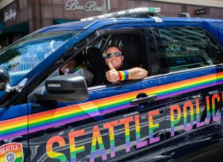 World Cup ‘Pride Match’ in Seattle to feature anti-LGBT nations Seattle, WA / USA - 30 June 2019: A Seattle police officer passes by in a cruiser during the Seattle Pride Parade showing support for LGBTQ rights.