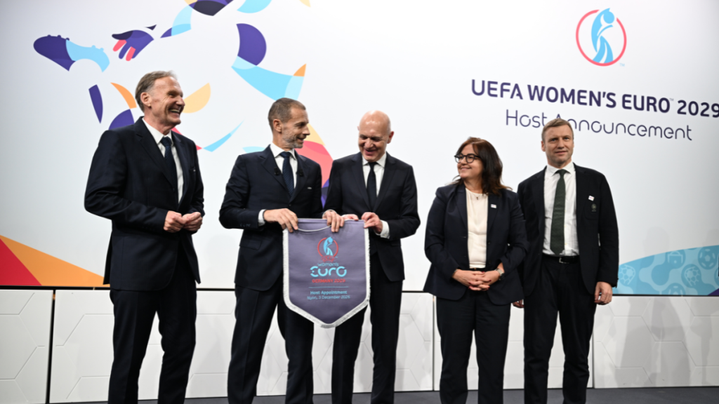 UEFA president Aleksander Ceferin congratulates the German bid team after they were chosen as the host of UEFA Women's Euro 2026