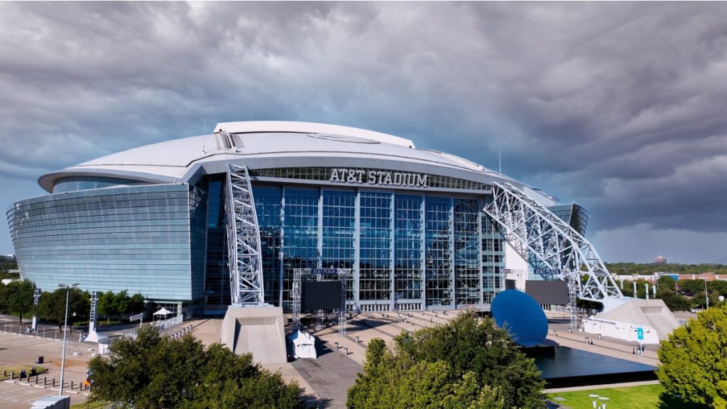 Dallas, Texas USA - 10 04 2025: Aerial drone photo of AT T Stadium in Arlington, Texas, with dramatic sky. The image captures the stadium’s modern architectural design with its iconic retractable roof.