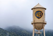 How Paramount beat Netflix to win Warner Bros Burbank, USA, Mar 12, 2023 – The iconic Warner Bros. water tower featuring the WB logotype on the studio lot in California, with low clouds and green hills in the background.
