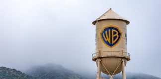 How Paramount beat Netflix to win Warner Bros Burbank, USA, Mar 12, 2023 – The iconic Warner Bros. water tower featuring the WB logotype on the studio lot in California, with low clouds and green hills in the background.