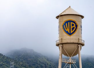 How Paramount beat Netflix to win Warner Bros Burbank, USA, Mar 12, 2023 – The iconic Warner Bros. water tower featuring the WB logotype on the studio lot in California, with low clouds and green hills in the background.