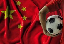 China unveils plan to build global sports powerhouse soccer football player on china flag background.