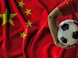 China unveils plan to build global sports powerhouse soccer football player on china flag background.