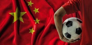China unveils plan to build global sports powerhouse soccer football player on china flag background.
