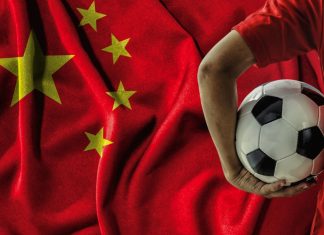 China unveils plan to build global sports powerhouse soccer football player on china flag background.