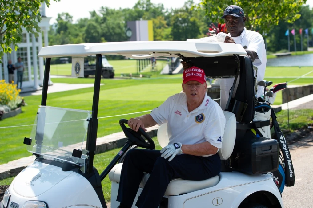 President Donald Trump drives to the next Tee at the start of the practice rounds at LIV Golf.