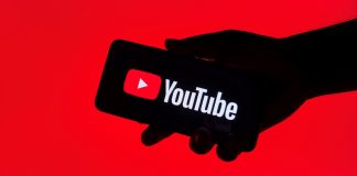 The Overlap goes all-in with The United Stand takeover Close up view of a hand holding a mobile phone with the YouTube application displayed.