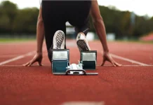 Inside the Enhanced Games and its business model Track and Field Athlete being ready in the blocks alone with no competition, sprinter, empty lanes, lonely, training, practise, spikes