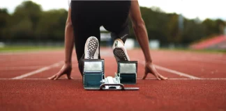 Inside the Enhanced Games and its business model Track and Field Athlete being ready in the blocks alone with no competition, sprinter, empty lanes, lonely, training, practise, spikes