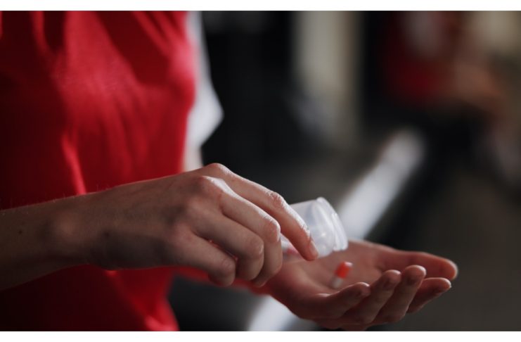 Do the Enhanced Games still work if the drugs don’t? Soccer player, hands and pills with vitamin supplement for sport, challenge or competition in locker room. Closeup, person or athlete with medication, antibiotic or prescription for game or match.