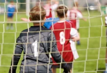 UK government plans to strip Sport England of planning powers Youth football goalkeeper in a grassroots match.