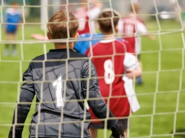 UK government plans to strip Sport England of planning powers Youth football goalkeeper in a grassroots match.