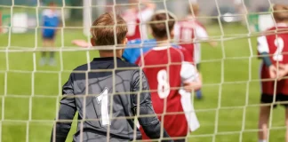 UK government plans to strip Sport England of planning powers Youth football goalkeeper in a grassroots match.