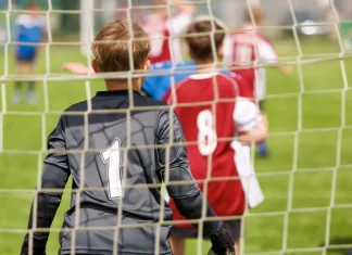 UK government plans to strip Sport England of planning powers Youth football goalkeeper in a grassroots match.
