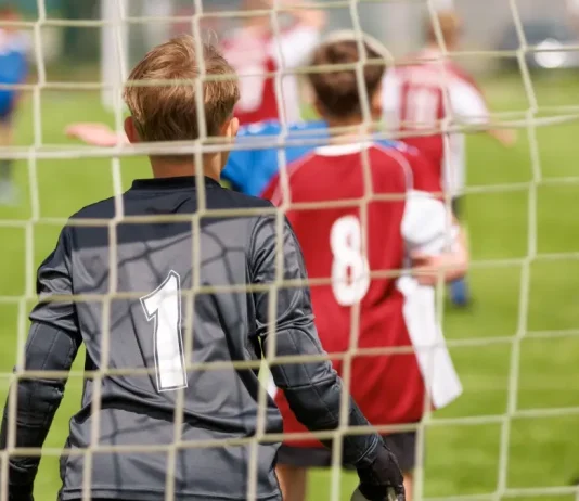UK government plans to strip Sport England of planning powers Youth football goalkeeper in a grassroots match.