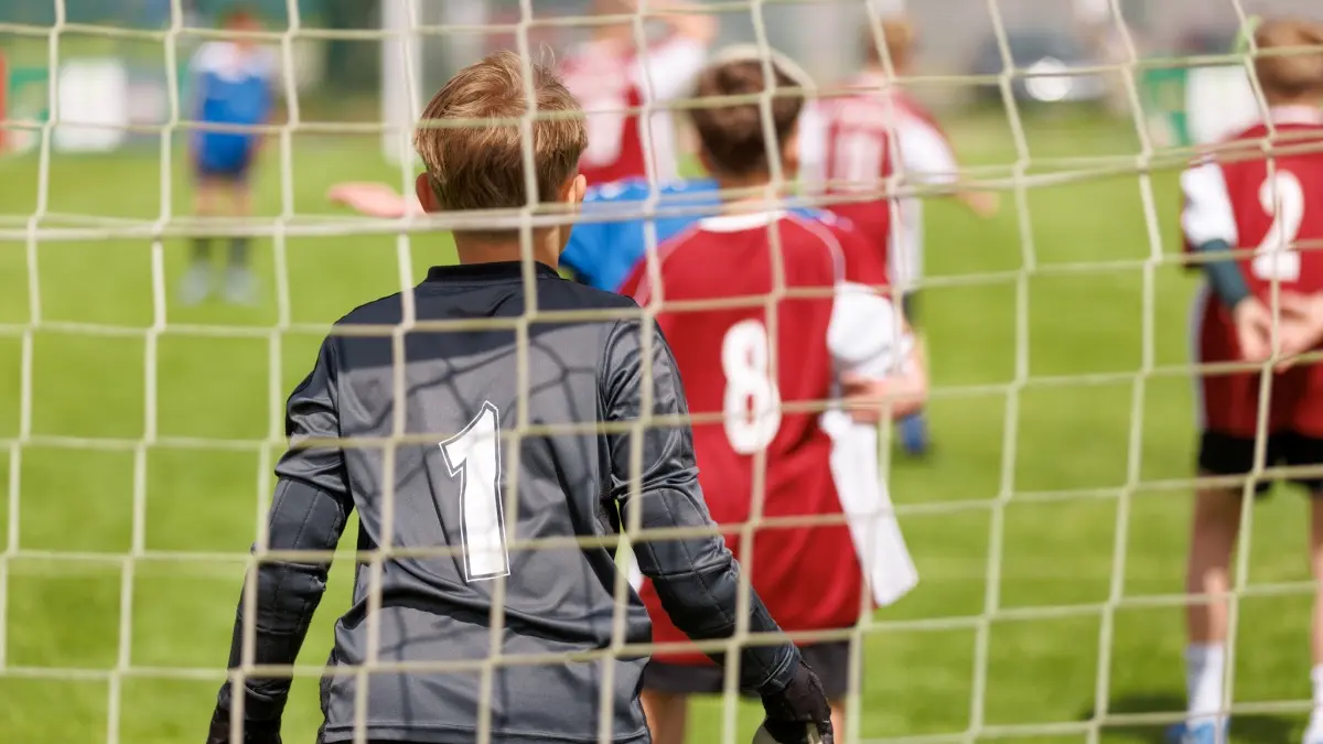 Youth football goalkeeper in a grassroots match.