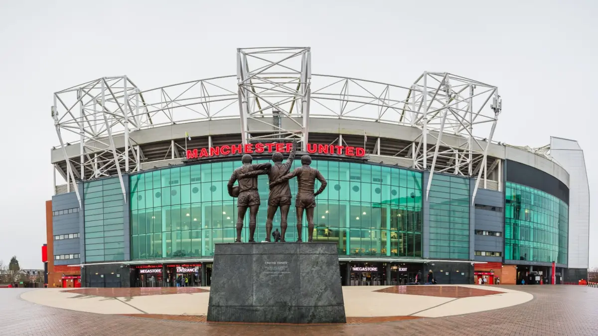 A multi image panorama of the United Trinity statue featuring Manchester United legends George Best, Denis Law and Sir Bobby Charlton pictured at Old Trafford stadium in Manchester