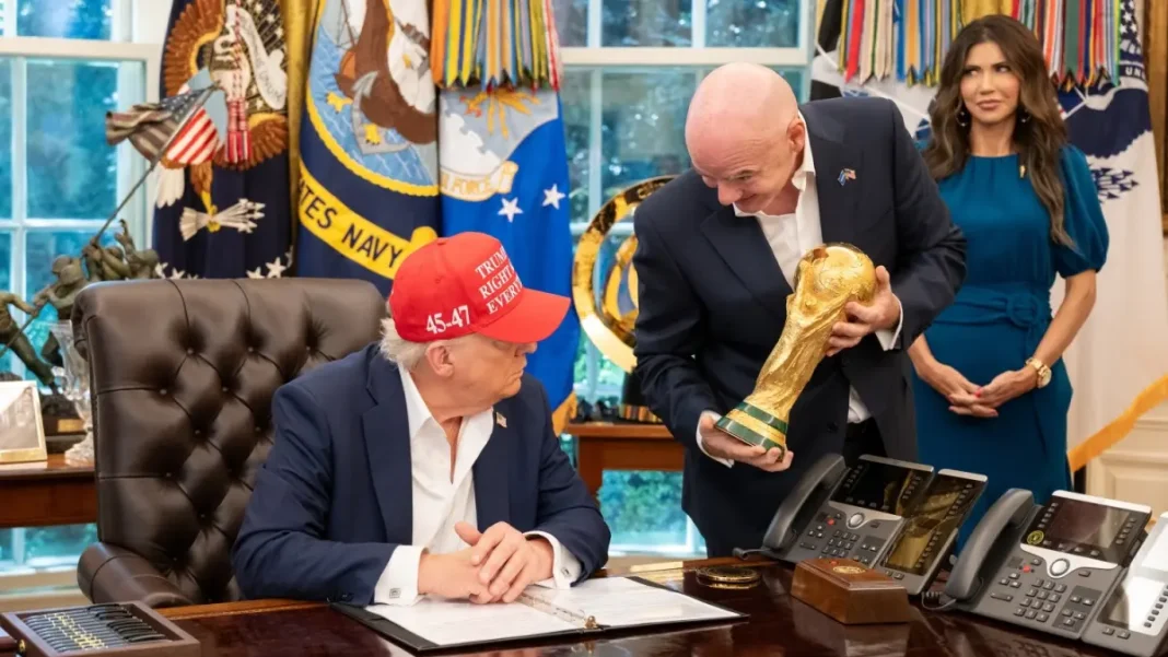 Infantino-and-Trump-with-wold-cup- President Donald Trump, flanked by Vice President JD Vance and FIFA President Gianni Infantino, announces that the FIFA World Cup draw