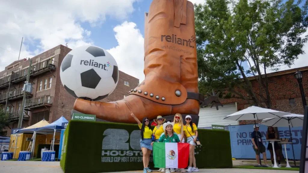 Mexican fans at World Cup stood in front of a massive cowboy boot in Houston. 