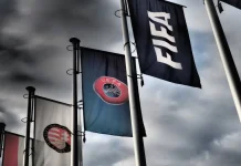 FIFA says UEFA is targeting Infantino’s re-election Budapest, Hungary - October 19, 2020: FIFA, UEFA and Hungarian Football Association flags in front of the Hungarian Football Association headquarters building in Budapest, Hungary in dramatic tone.