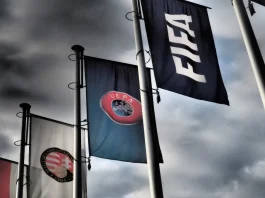FIFA says UEFA is targeting Infantino’s re-election Budapest, Hungary - October 19, 2020: FIFA, UEFA and Hungarian Football Association flags in front of the Hungarian Football Association headquarters building in Budapest, Hungary in dramatic tone.