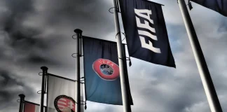 FIFA says UEFA is targeting Infantino’s re-election Budapest, Hungary - October 19, 2020: FIFA, UEFA and Hungarian Football Association flags in front of the Hungarian Football Association headquarters building in Budapest, Hungary in dramatic tone.
