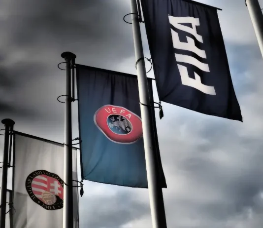 FIFA says UEFA is targeting Infantino’s re-election Budapest, Hungary - October 19, 2020: FIFA, UEFA and Hungarian Football Association flags in front of the Hungarian Football Association headquarters building in Budapest, Hungary in dramatic tone.