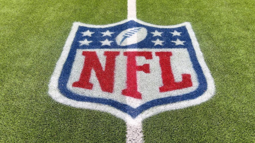 Inglewood, CA, USA - November 14, 2024: An NFL logo on a green artificial grass football field line in full color.
