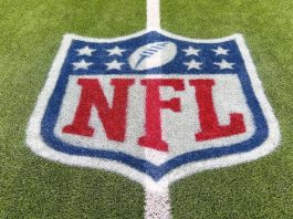 Goodell hints NFL could exit rights deals early Inglewood, CA, USA - November 14, 2024: An NFL logo on a green artificial grass football field line in full color.