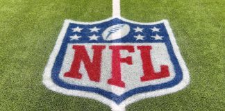 Goodell hints NFL could exit rights deals early Inglewood, CA, USA - November 14, 2024: An NFL logo on a green artificial grass football field line in full color.