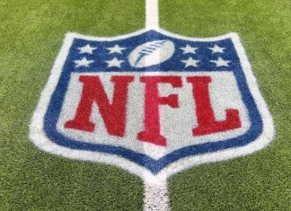 Goodell hints NFL could exit rights deals early Inglewood, CA, USA - November 14, 2024: An NFL logo on a green artificial grass football field line in full color.