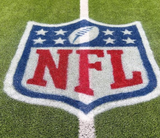 Goodell hints NFL could exit rights deals early Inglewood, CA, USA - November 14, 2024: An NFL logo on a green artificial grass football field line in full color.